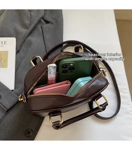Internal view of dark brown doctor bag showing capacity for phone and accessories