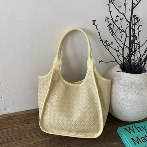 Detailed close-up showing the premium woven leather texture of the beige hobo tote bag