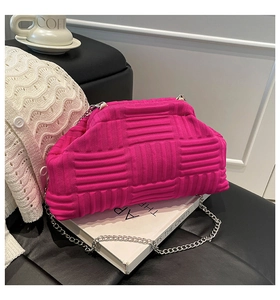 Detail of fuchsia knitted shell bag with textured weave and silver chain strap