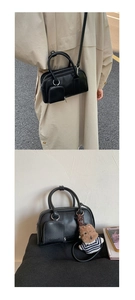 Detail of minimalist black crossbody bag with detachable mini pouch and teddy bear charm