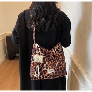 Detail of leopard print canvas tote bag featuring MULAIDI label and cute toast charm