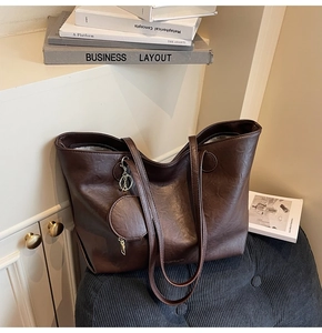 Detail of dark brown faux leather tote bag with a matching round mini coin purse