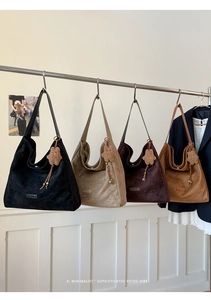 Detailed display of four suede tote bags in black, khaki, dark coffee, and caramel colors