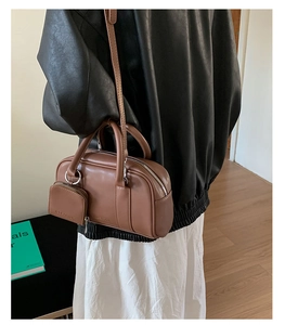 Brown vintage baguette bag detail featuring a mini detachable coin purse and silver hardware