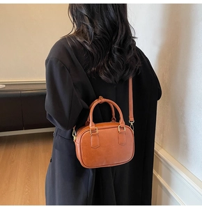 Brown retro small square bag for women with dual handles and gold metal accents