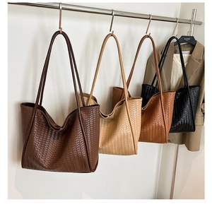 Close-up of woven tote bags in brown, beige, caramel, and black for a minimalist look