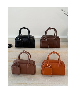Four colors of leather square handbags with matching coin purses on stone steps