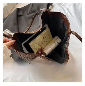 Interior view showing the large capacity of a brown woven tote bag for essentials