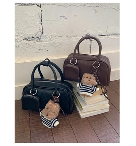Detail of retro mini square handbags in black and brown with cute plush bear charms