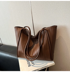 Detailed view of the dark brown leather woven pattern on this large commute tote bag