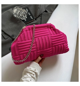 Detail shot of hot pink knitted cloud bag with a chunky silver metal chain strap