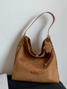 Brown suede hobo tote bag with a leather strap and cute bear charm for daily commute