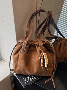 Vintage brown faux suede tote bag with drawstring closure and beaded tassel charm