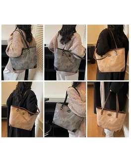 Detailed view of large capacity tote bag in grey and brown faux leather textured finish