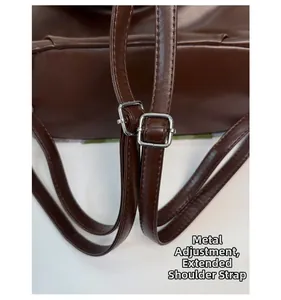 Detail of adjustable deep brown leather strap with silver hardware and precise stitching