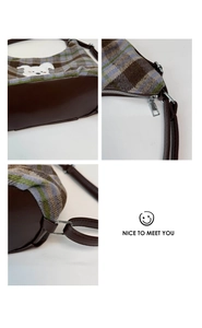 Detail of plaid wool tote bag with white animal embroidery and metal zipper texture