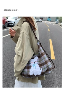 Outdoor model show of a retro plaid tote bag with plush cartoon dog patch embroidery