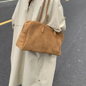 Détail du sac cabas en daim marron avec fermeture éclair et doubles bandoulières