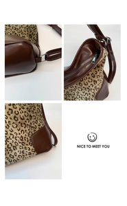 Macro detail of leopard print canvas with smooth brown leather stitching and silver zipper