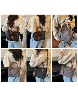 Dettaglio delle borse tote in nylon nero e grigio con manici in pelle marrone
