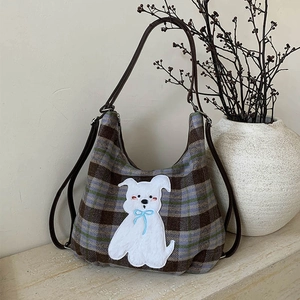 Close-up of vintage plaid wool tote bag featuring cute dog embroidery and premium stitching