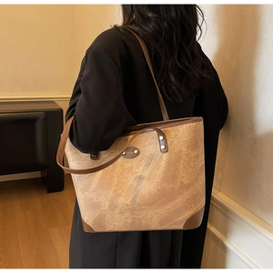 Detail of vintage marble texture and brown leather handles on large capacity tote bag