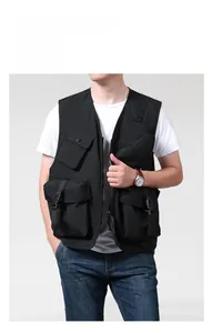 Detail of black outdoor utility vest showing multiple pockets and durable zip closure