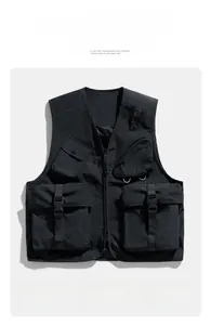 Detail of black utility vest with four cargo pockets and durable zippers for outdoors