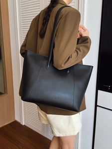Large black matte leather tote bag for women showing a spacious casual shoulder style