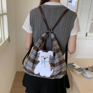 Detailed view of plaid wool tote bag featuring a cute puppy embroidery and leather straps