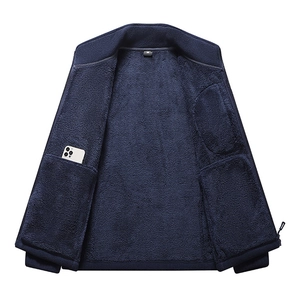 Detail of a navy blue fleece jacket showing a functional inner pocket with a white phone