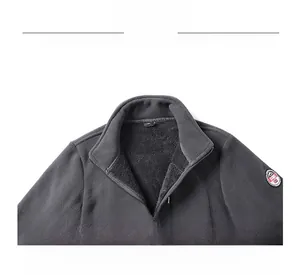 Detailed view of the stand-up collar and sport embroidered patch on dark grey fleece jacket