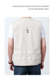 Detail of khaki outdoor vest showing waterproof fabric and rear D-ring hook
