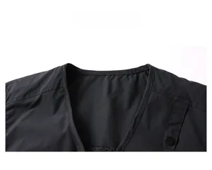 Close-up of black outdoor vest V-neckline with double-stitch detail and snap button