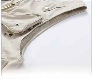 Detail of multi-pocket tactical vest featuring breathable mesh lining and a metal D-ring