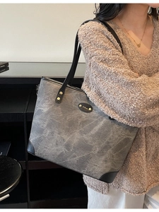 Minimalist grey marble texture tote bag with black leather trim and long shoulder straps