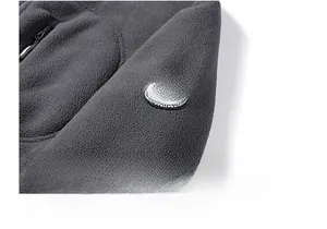 Detail of dark grey fleece jacket sleeve featuring a circular sport expedition patch