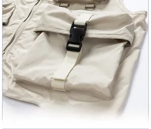 Detail of cargo vest featuring 3D pockets with black buckle closures and matte fabric