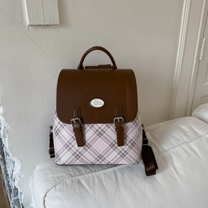 Detail of pink plaid school backpack with brown leather flap and bunny logo