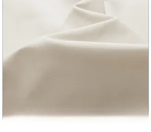 Close-up of beige twill cotton fabric texture for multi-pocket utility vest