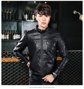 Detail of slim fit black faux leather biker jacket with stand collar and metal zippers