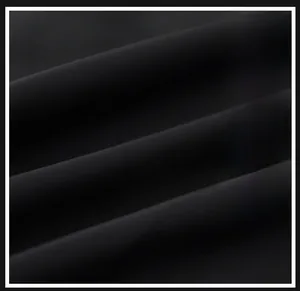 Detail shot of black bomber jacket fabric showing tight knit texture and matte finish