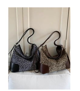 Close-up of leopard print hobo bags featuring leather trim and premium fabric texture