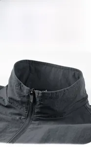 Macro detail of charcoal grey men's jacket showing collar stitching and zipper design