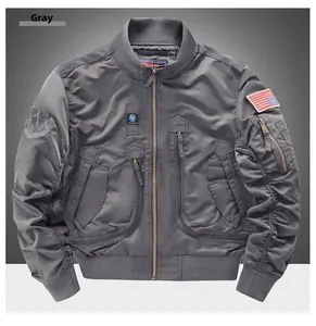 Detail of grey MA-1 bomber jacket featuring tactical patches and ribbed baseball collar