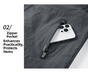 Detail view of a men's dark grey windbreaker featuring a secure functional zipper pocket