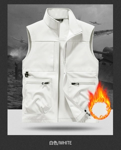 Close-up of white softshell outdoor vest featuring multiple zipper pockets and stand collar
