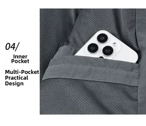 Detail view of large inner mesh pocket on grey jacket holding a smartphone