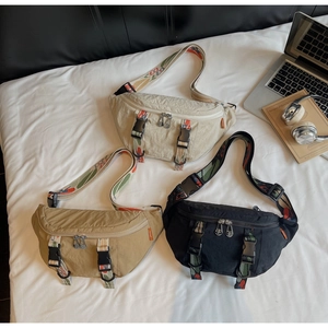 Detailed flat lay of nylon chest bags in black, beige, and khaki with wide patterned straps