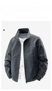 Detail of dark grey men's stand collar jacket featuring elastic cuffs and zip closure